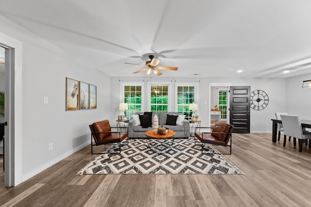 living room with ceiling fan, wood finished floors, baseboards, and recessed lighting