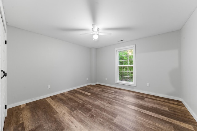 empty room with a ceiling fan, wood finished floors, and baseboards