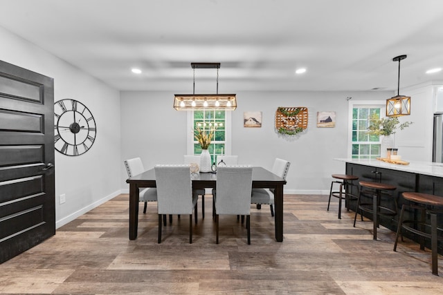 dining area with recessed lighting, wood finished floors, and baseboards