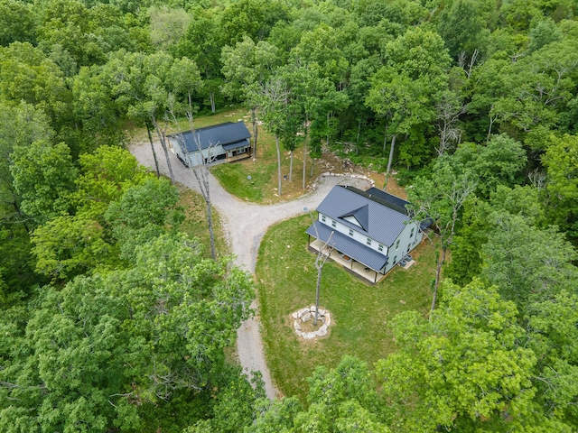 view of subject property with a forest