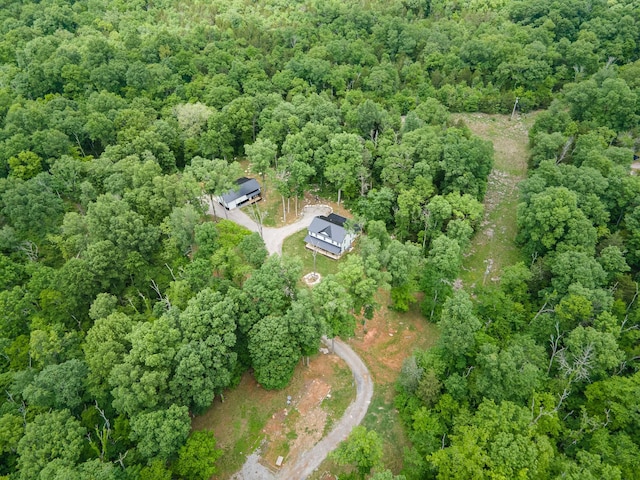 aerial view of property's location featuring a heavily wooded area