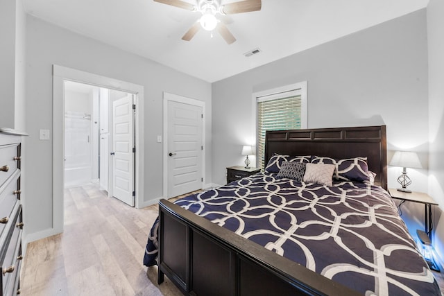 bedroom featuring light wood-style floors, ceiling fan, and connected bathroom
