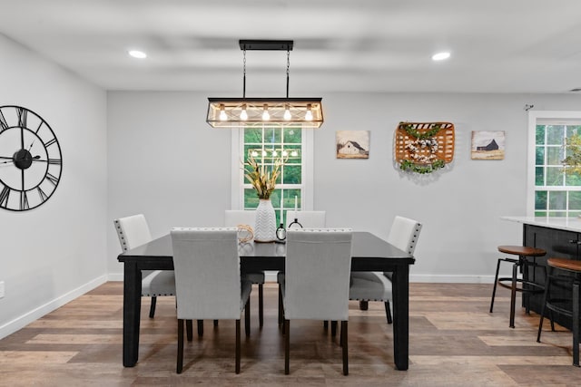 dining space featuring wood finished floors, baseboards, and recessed lighting