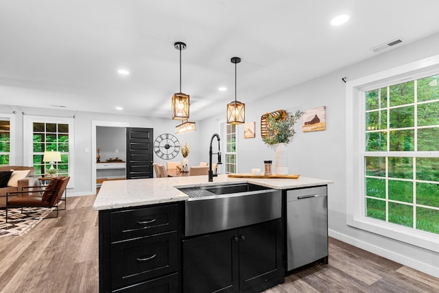 kitchen featuring stainless steel dishwasher, dark cabinetry, baseboards, a sink, and recessed lighting