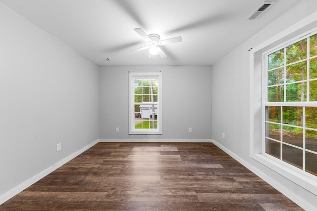 unfurnished room with ceiling fan, dark wood-style flooring, and baseboards