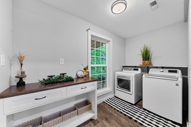 laundry room featuring washer and dryer and dark wood-style flooring
