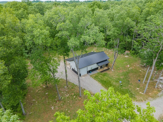 aerial view of property and surrounding area featuring a forest