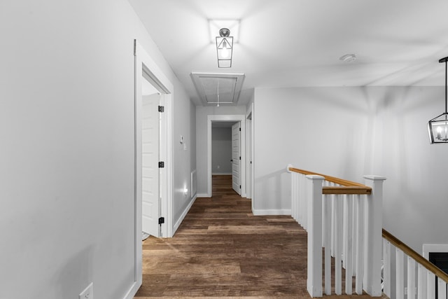 hallway with attic access, an upstairs landing, wood finished floors, and baseboards