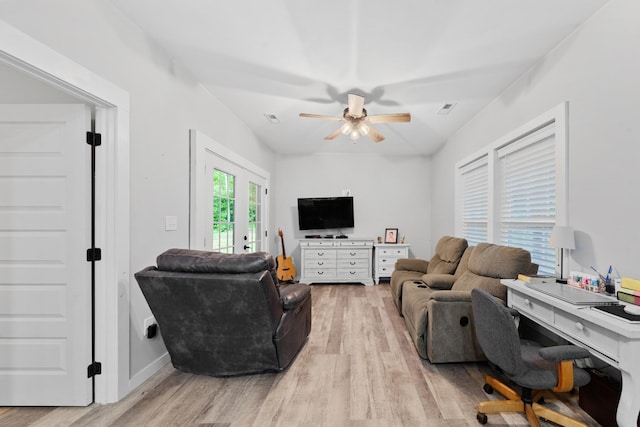 living room featuring light wood-style flooring, a ceiling fan, an office area, and baseboards