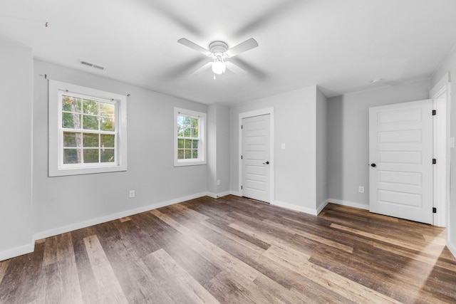 unfurnished bedroom with wood finished floors, baseboards, and ceiling fan