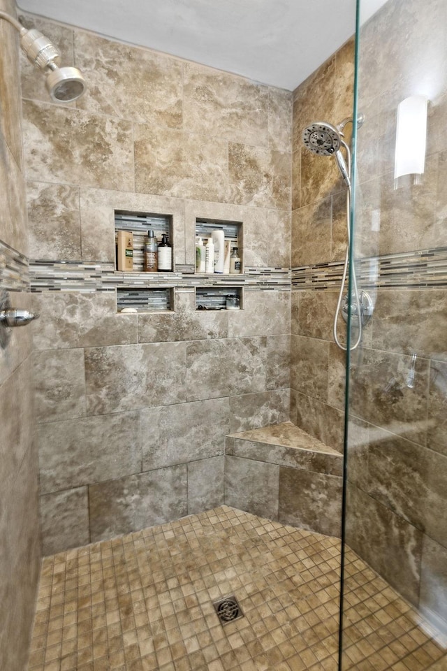 bathroom with a tile shower