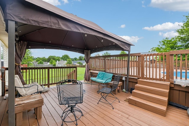 wooden deck with a gazebo and a yard