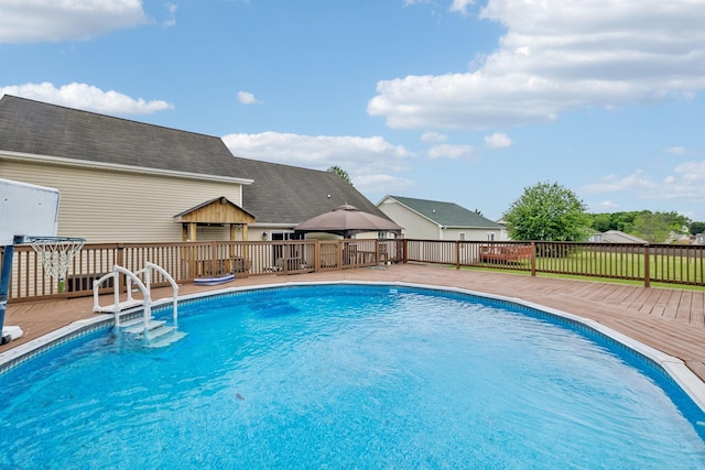 view of pool with a gazebo and a wooden deck