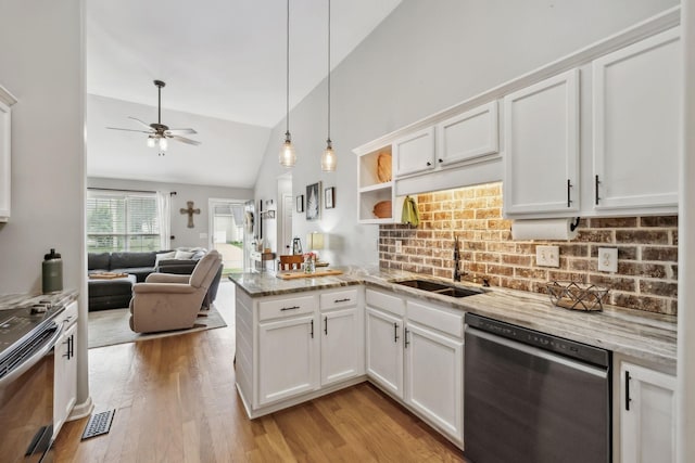 kitchen with appliances with stainless steel finishes, a peninsula, ceiling fan, lofted ceiling, and white cabinetry