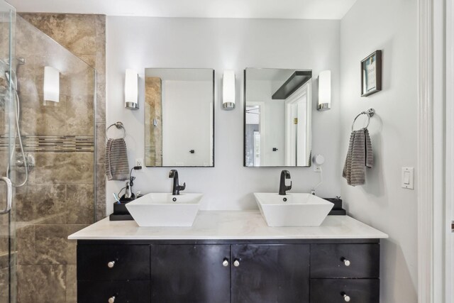 full bath featuring a shower stall and double vanity