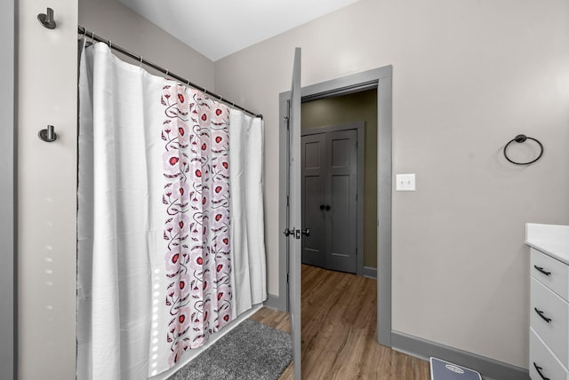 996 Gratton Rd, Clarksville, TN 37043 - full bathroom with wood finished floors, vanity, baseboards, and curtained shower