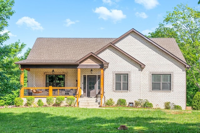996 Gratton Rd, Clarksville, TN 37043 - view of front of property with brick siding, a porch, a front yard, and a shingled roof