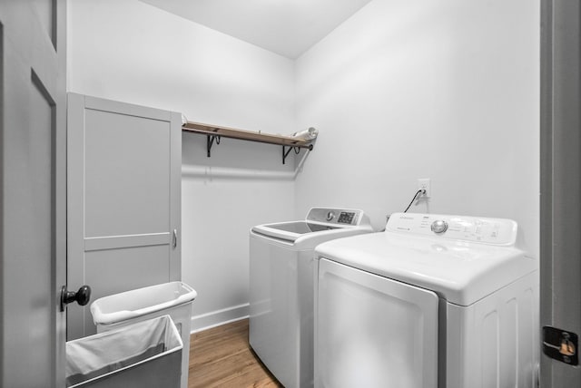 996 Gratton Rd, Clarksville, TN 37043 - laundry area with washer and clothes dryer, light wood finished floors, and baseboards