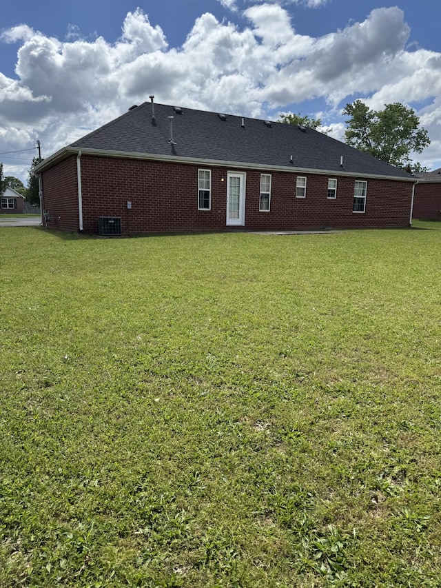 9104 Eddystone Ct, Smyrna, TN 37167 - back of property with central AC, a lawn, and brick siding