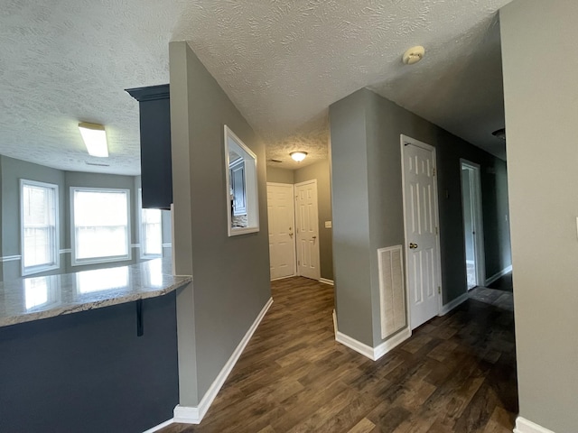 9104 Eddystone Ct, Smyrna, TN 37167 - hallway with dark wood-style flooring, a textured ceiling, and baseboards