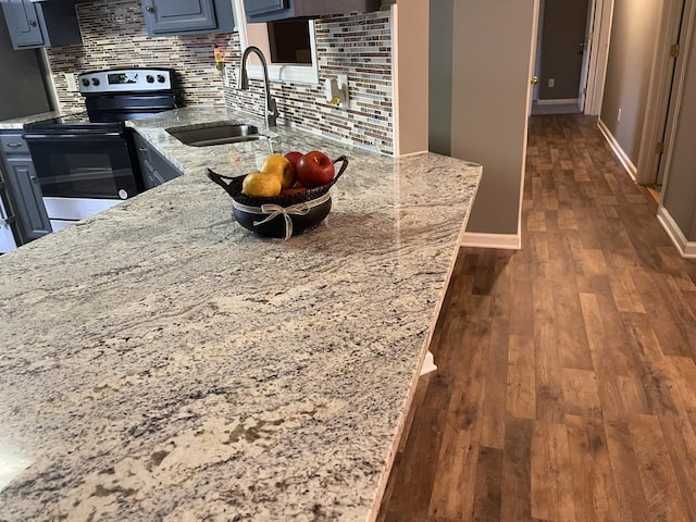 9104 Eddystone Ct, Smyrna, TN 37167 - kitchen with range with electric stovetop, a sink, baseboards, backsplash, and dark wood-type flooring