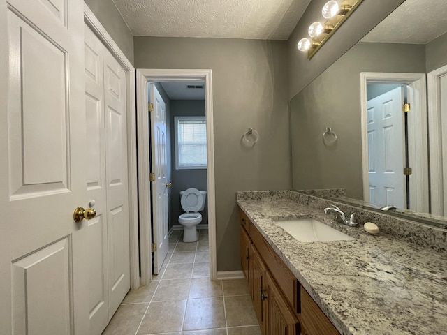 9104 Eddystone Ct, Smyrna, TN 37167 - bathroom with toilet, vanity, tile patterned floors, a textured ceiling, and baseboards
