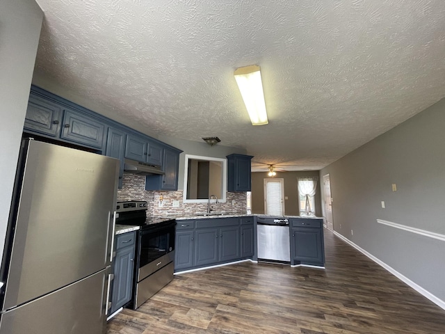 9104 Eddystone Ct, Smyrna, TN 37167 - kitchen featuring appliances with stainless steel finishes, a sink, a peninsula, a ceiling fan, and a textured ceiling