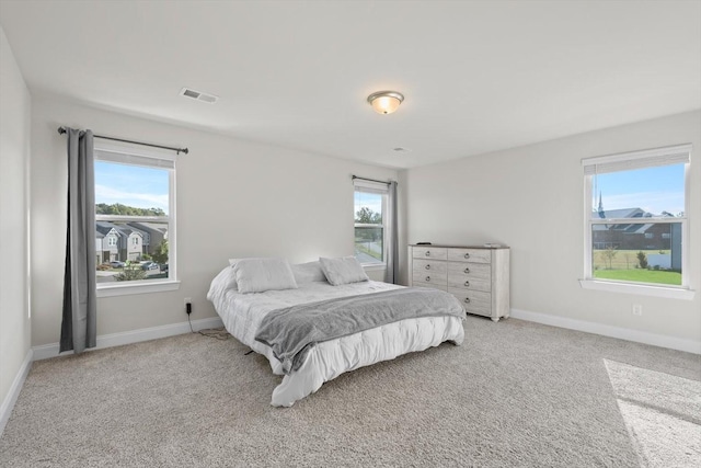 carpeted bedroom with baseboards