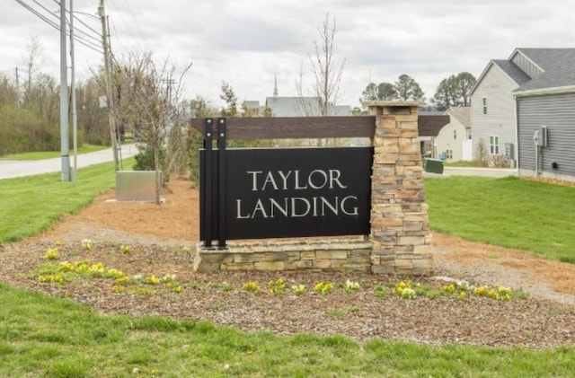 community / neighborhood sign with a lawn