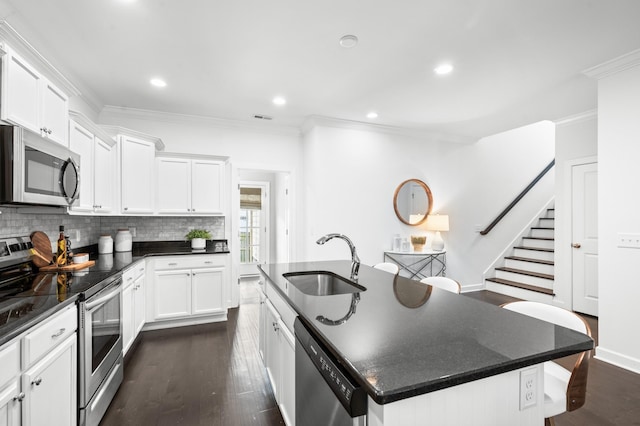 4085 Liberton Way, Nolensville, TN 37135 - kitchen featuring stainless steel appliances, a sink, an island with sink, ornamental molding, and dark wood finished floors