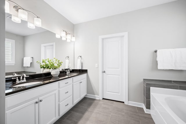 4085 Liberton Way, Nolensville, TN 37135 - bathroom featuring baseboards, double vanity, and a bath
