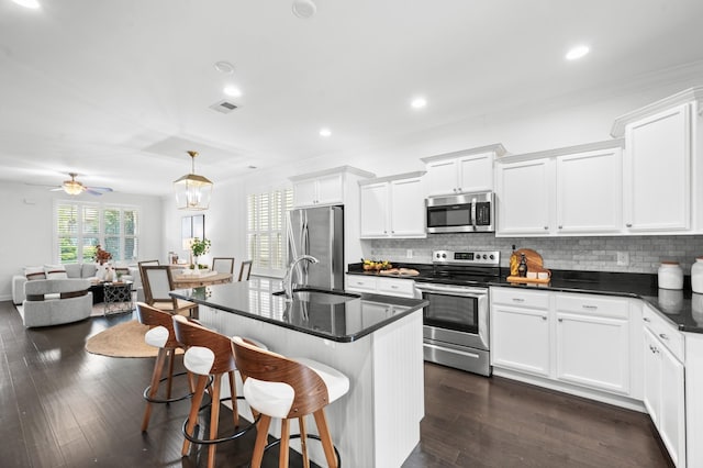 4085 Liberton Way, Nolensville, TN 37135 - kitchen featuring appliances with stainless steel finishes, a sink, a breakfast bar area, tasteful backsplash, and crown molding