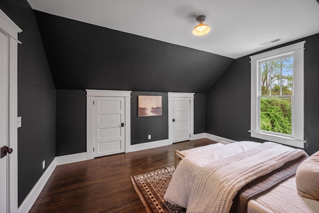 bedroom featuring vaulted ceiling, wood finished floors, and baseboards