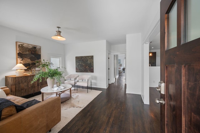 living area with wood finished floors and baseboards