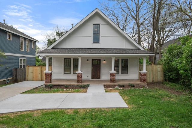 view of front facade with a porch and a shingled roof