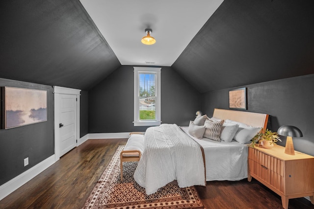 bedroom with wood finished floors, baseboards, and vaulted ceiling