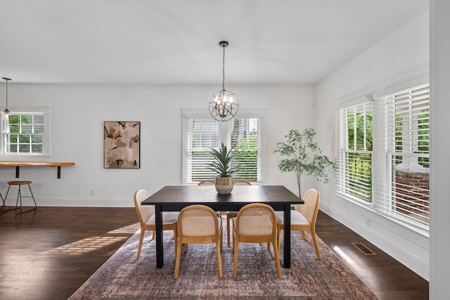 dining space with plenty of natural light, dark wood-style flooring, a chandelier, and baseboards