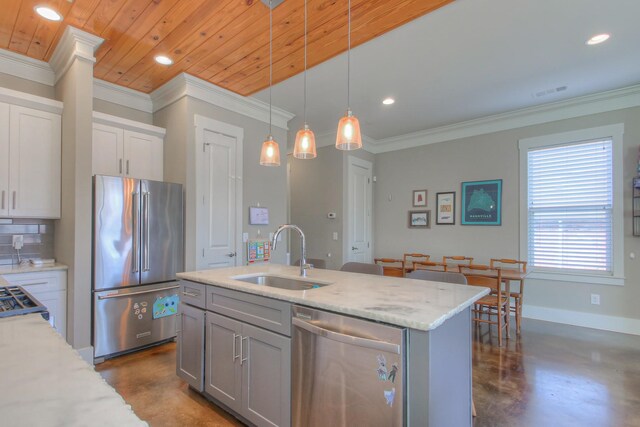 kitchen featuring appliances with stainless steel finishes, a sink, concrete floors, recessed lighting, and pendant lighting