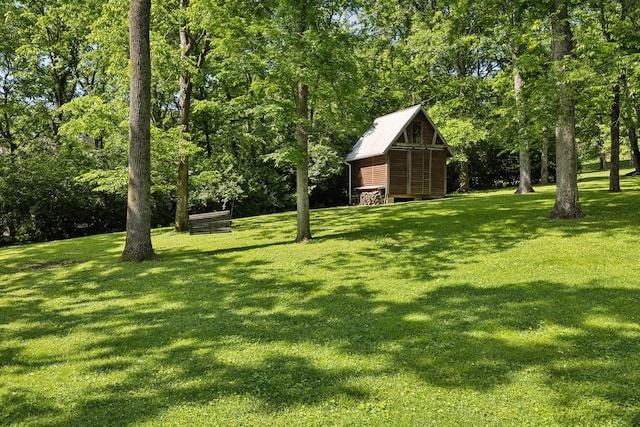 view of green lawn with an outbuilding