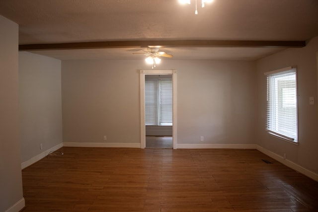 empty room with a ceiling fan, beam ceiling, wood finished floors, and baseboards