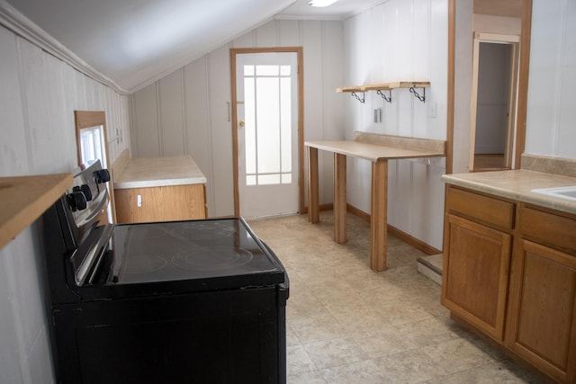 kitchen featuring black range with electric stovetop, vaulted ceiling, open shelves, brown cabinets, and light countertops