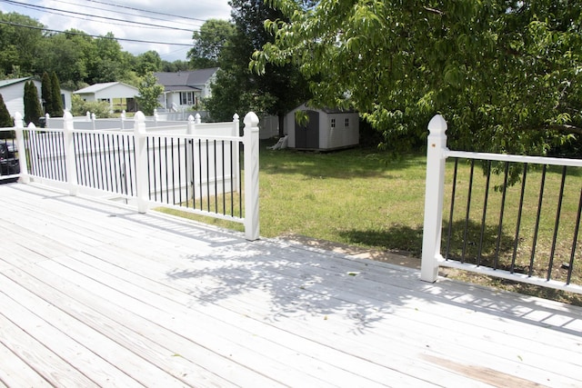 wooden deck featuring a storage unit and an outdoor structure