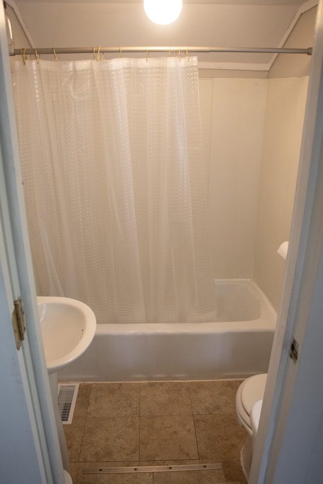 full bathroom with toilet, shower / tub combo with curtain, and tile patterned floors