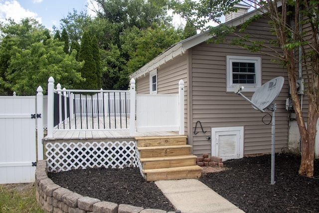 doorway to property featuring a wooden deck and fence