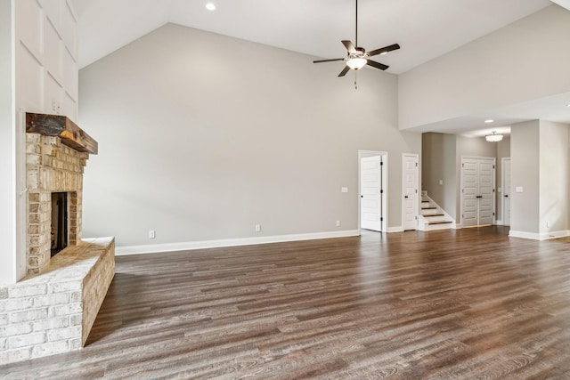 7575 Carthage Hwy, Lebanon, TN 37087 - unfurnished living room featuring high vaulted ceiling, a ceiling fan, a brick fireplace, baseboards, and dark wood-style flooring
