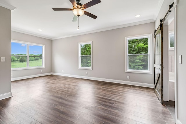 7575 Carthage Hwy, Lebanon, TN 37087 - spare room featuring a barn door, crown molding, plenty of natural light, dark wood-type flooring, and recessed lighting