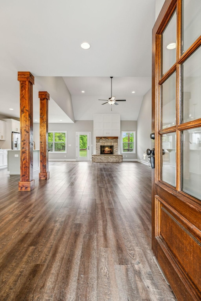 7575 Carthage Hwy, Lebanon, TN 37087 - unfurnished living room featuring ceiling fan, vaulted ceiling, dark wood finished floors, ornate columns, and baseboards