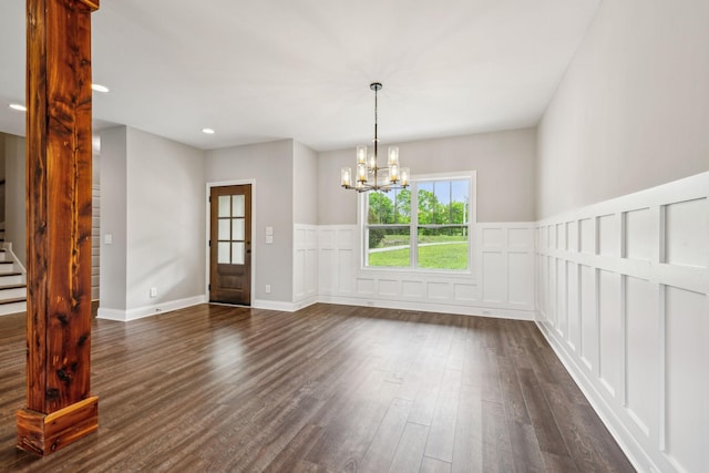 7575 Carthage Hwy, Lebanon, TN 37087 - unfurnished dining area featuring dark wood finished floors, a chandelier, stairway, wainscoting, and a decorative wall