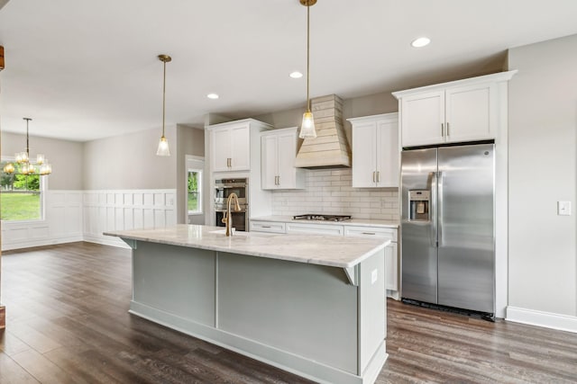 7575 Carthage Hwy, Lebanon, TN 37087 - kitchen with appliances with stainless steel finishes, premium range hood, dark wood-style flooring, white cabinetry, and wainscoting