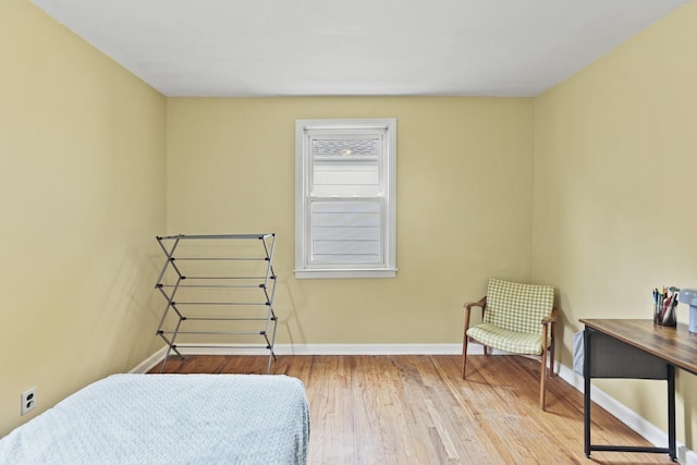 bedroom featuring baseboards and wood finished floors